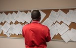 NEW YORK - JUNE 24: A job seeker looks over t... NEW YORK - JUNE 24: A job seeker looks over t...